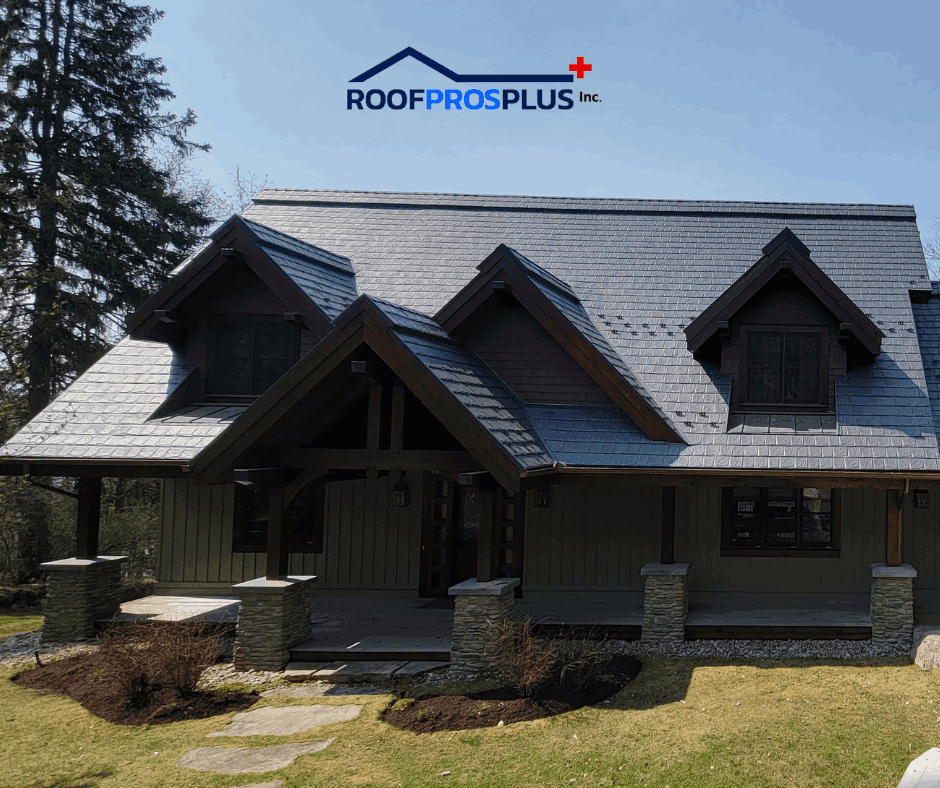 A rustic house with a large, dark metal roof and wooden beams. The logo "Roof Pros Plus" is at the top. Trees and grass surround the home.