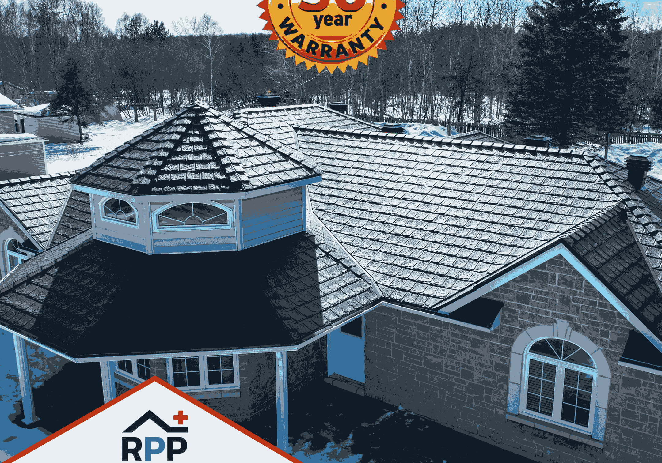 An aerial view of a house with a metal shingled roof. A '50-year transferable warranty' badge is prominent. Trees and snowy ground in the background. Text reads, 'Our roofs are built to last a lifetime!' with the RPP logo above the text.