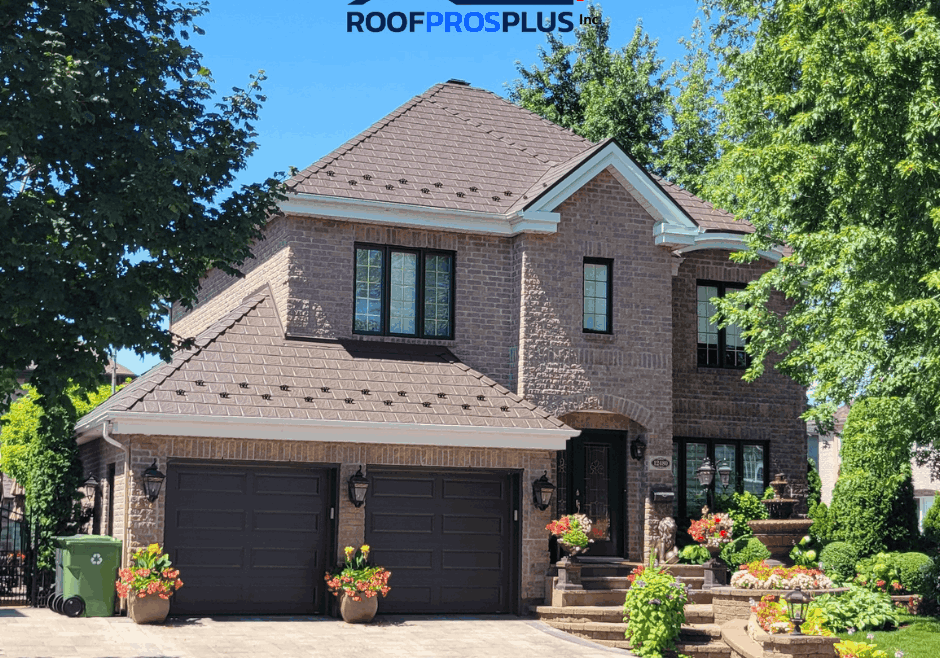 Brick house with brown metal roof, two-car garage, and manicured landscaping. Bright sunny day, trees are framing the home. The logo for "Roof Pros Plus" at the top.