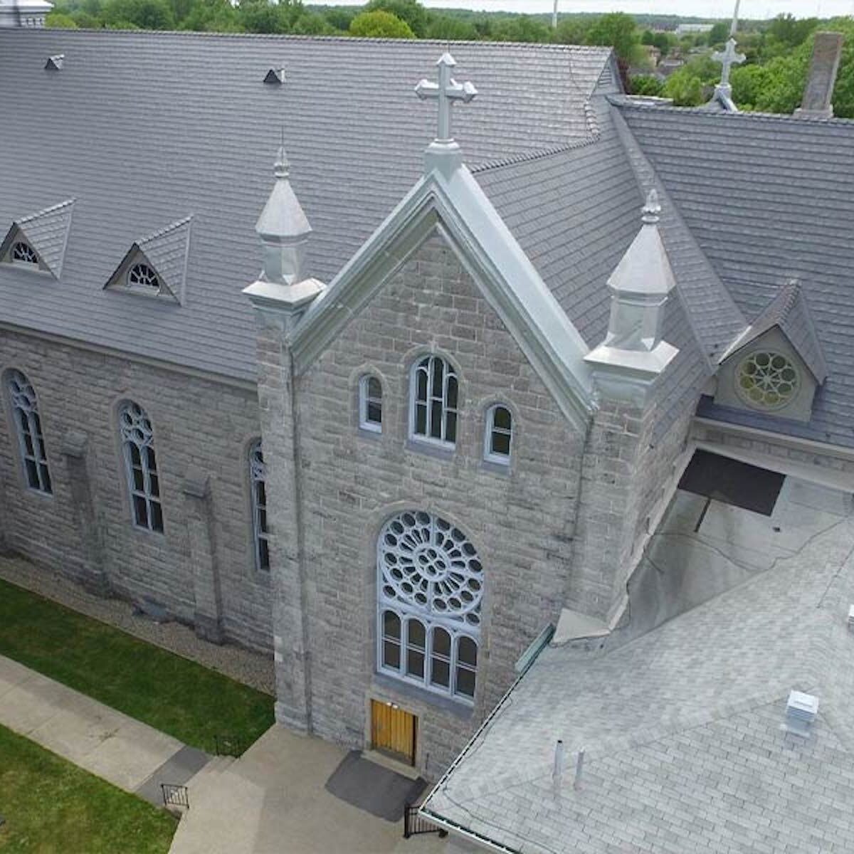 metal roof install in stone colour for a church
