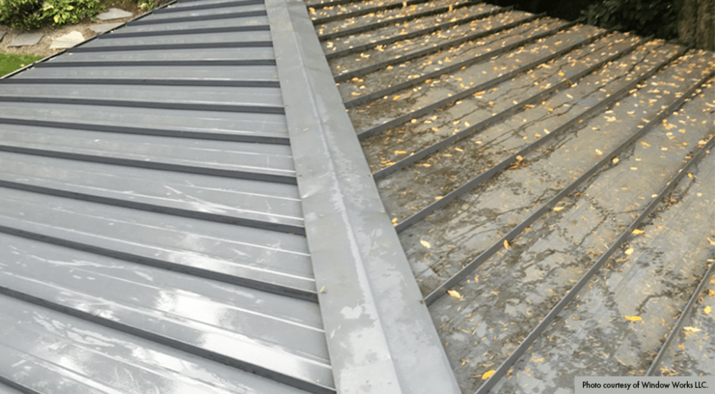 A close-up image of side-by-side roofs. One side is damaged from the environment and has an accumulation of fallen leaves, while the other is clean in good condition.