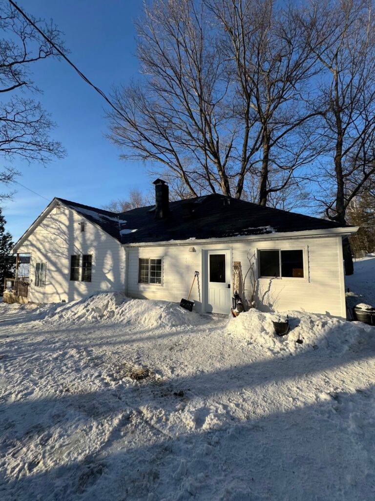 Winter home with fresh new metal roofing system by Roof Pros Plus