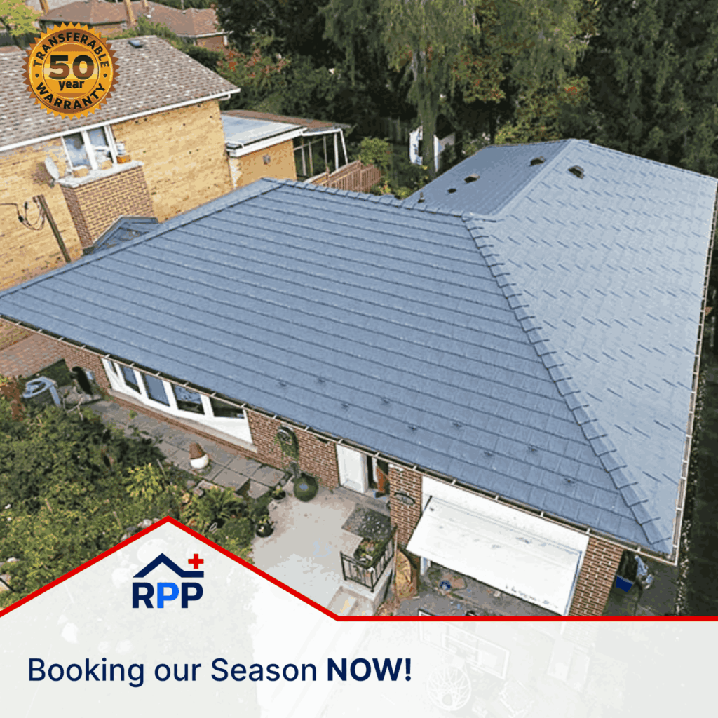 Aerial view of a building with a newly installed blue metal roof surrounded by greenery. A "50-year transferable warranty" badge is at the top left. Text reads "RPP, Booking our Season NOW!"
