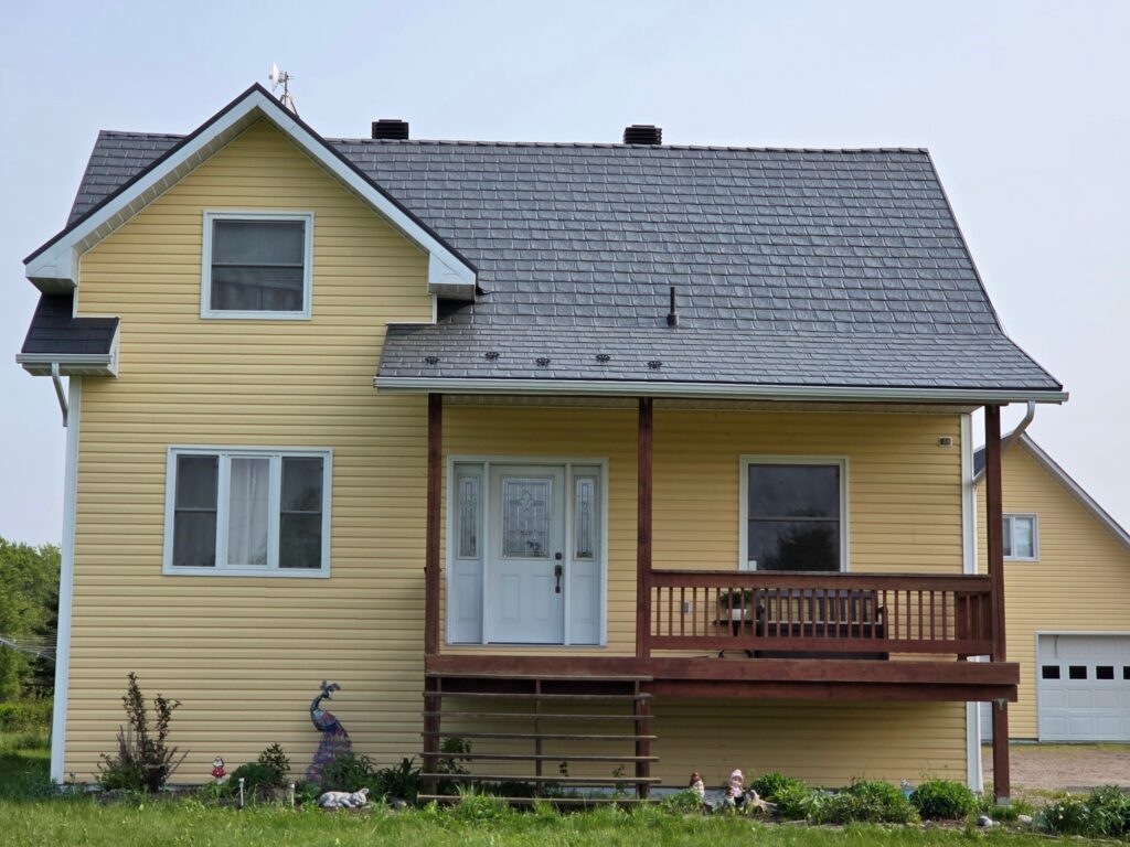 light yellow house with metal roof in Ontario