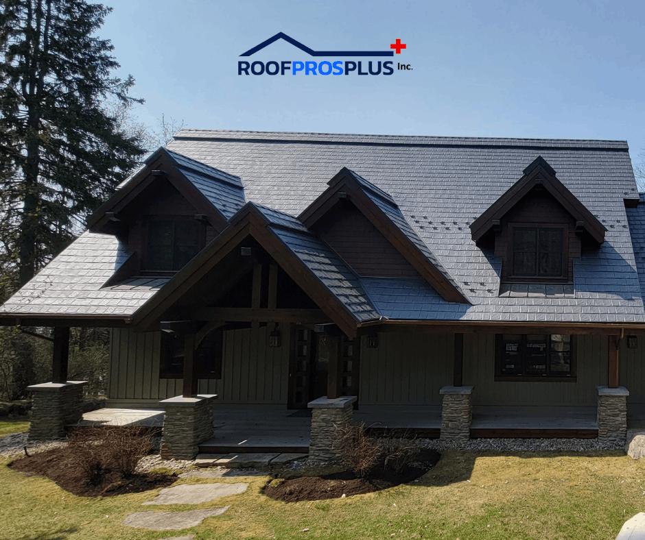 A rustic house with a dark, sloped metal roof and wooden beams sits in a grassy yard. "RoofProsPlus Inc." logo is visible at the top of the graphic. 