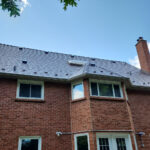 Black steel roof on red brick house Northern Ontario